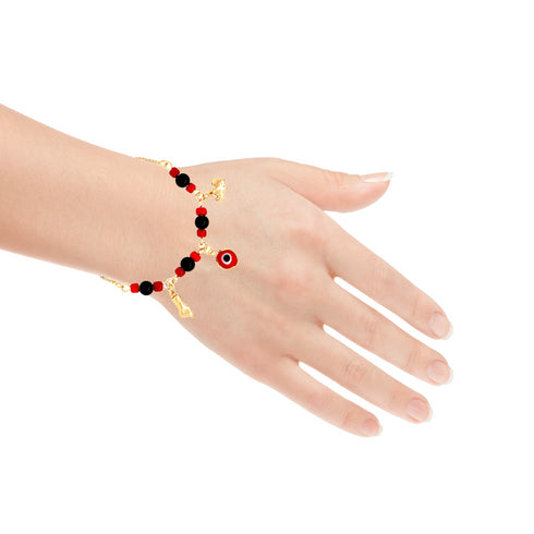 A hand adorned with a Red and Black Evil Eye, Figa Hand, and Elephant Lucky Charm bracelet, adjustable and gold-filled, elegantly displays its intricate design of black beads, red accents, and a dangling evil eye charm against a plain white background. The fingers are relaxed and slightly spread apart.